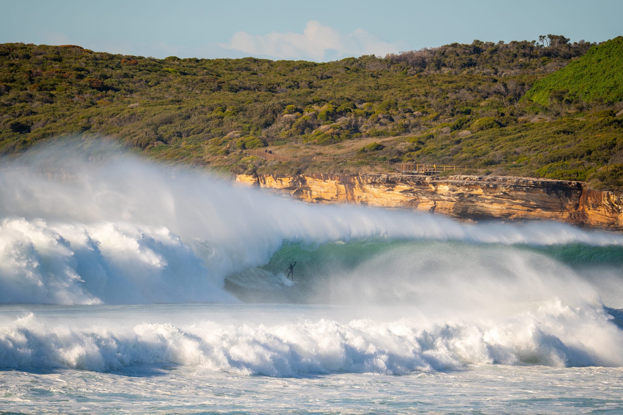 Solo — a single surfer paddling out